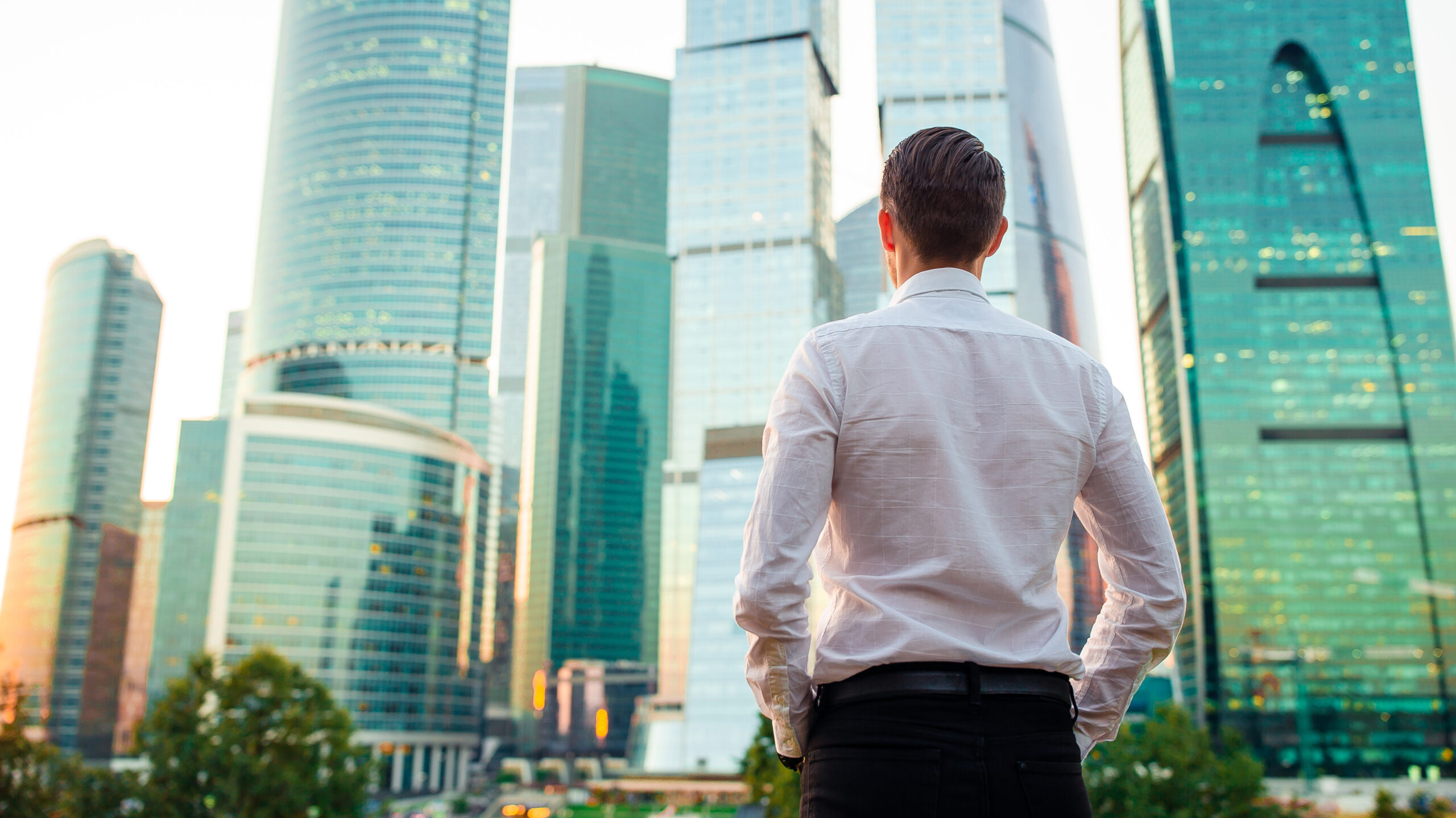 Businessman looking at a glass skyscraper